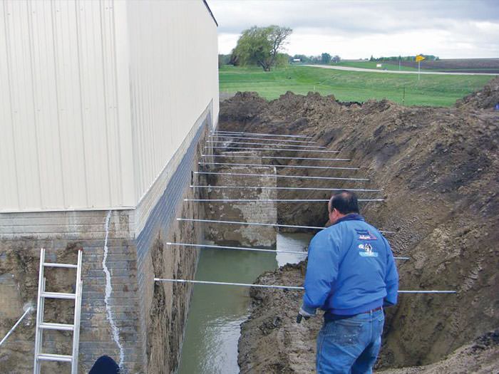 Repairing Straightening Tilting Foundation Walls By Authorized Drilling The Hole In Foundation Wall For Street Creep Repairs Plattsmouth