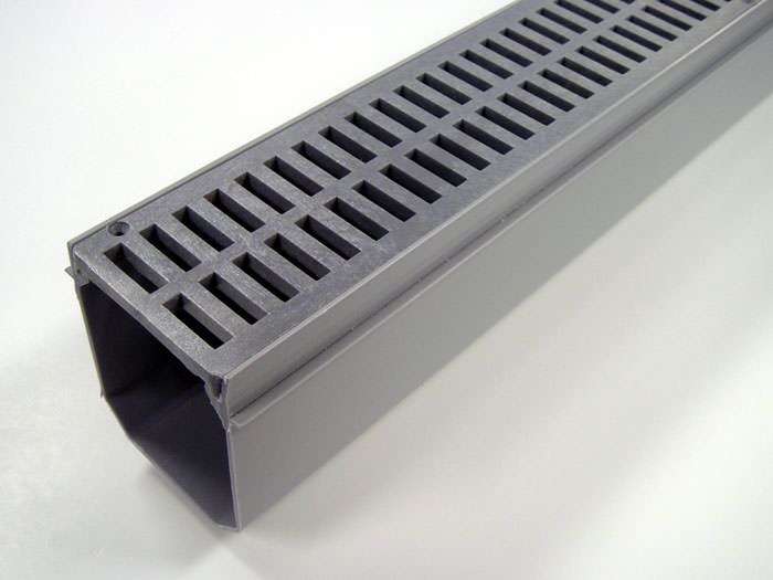 A closeup of our grated basement drainage pipe system, installed in Spencer