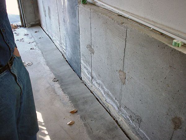 an ugly basement weeping tile drainage system that's clogged and not working in Bellevue.