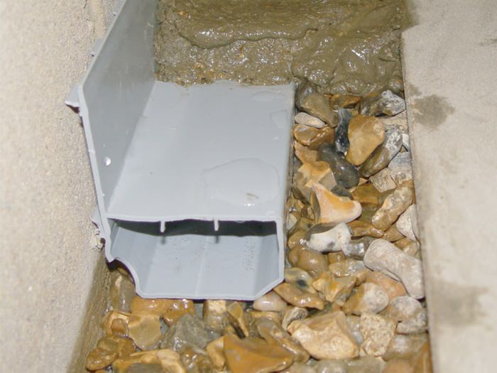 A no-clog basement french drain system installed in Norfolk